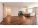Large, open living room boasts wood floors, neutral walls, recessed lighting, ceiling fan, and lots of natural light at 10417 Artful Stone Ave, Las Vegas, NV 89149