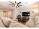 Comfortable living room features wood floors, ceiling fan, and neutral color palette, great for entertaining guests at 10417 Artful Stone Ave, Las Vegas, NV 89149