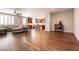 Open-concept living area showcasing hardwood floors, a ceiling fan, and seamless flow into the kitchen at 10417 Artful Stone Ave, Las Vegas, NV 89149