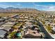 Wide aerial view of homes in a suburban community, showcasing pools and mountain views at 10417 Artful Stone Ave, Las Vegas, NV 89149