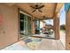 Covered patio with ceiling fans and outdoor seating area at 10417 Artful Stone Ave, Las Vegas, NV 89149