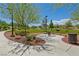 Serene picnic area with tables, a grill, landscaping and walkway in a neighborhood park at 10417 Artful Stone Ave, Las Vegas, NV 89149