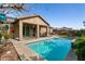 Inviting pool with covered patio, perfect for outdoor relaxation and entertaining at 10417 Artful Stone Ave, Las Vegas, NV 89149