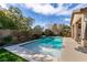 Backyard pool with waterfall feature, patio, and manicured landscaping at 10417 Artful Stone Ave, Las Vegas, NV 89149