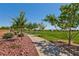 Picturesque walking path with lush landscaping in a well-maintained community at 10417 Artful Stone Ave, Las Vegas, NV 89149