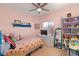 Bright, cheerful bedroom with pink walls, colorful decor and shelving at 10754 Balmoral St, Las Vegas, NV 89141