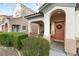 Inviting front porch with decorative wreath and manicured bushes at 10754 Balmoral St, Las Vegas, NV 89141