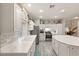 Bright kitchen featuring stainless steel appliances, white cabinetry, and marble countertops at 10754 Balmoral St, Las Vegas, NV 89141
