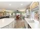 Open kitchen featuring white cabinets, island with countertop and seamless flow to dining and living areas at 10754 Balmoral St, Las Vegas, NV 89141