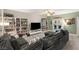 Bright living room featuring a cozy sofa, built-in bookshelves, and a view of the backyard at 10754 Balmoral St, Las Vegas, NV 89141