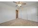 This cozy bedroom offers a ceiling fan, neutral carpet, and a convenient closet for ample storage at 1158 Gecko Rd, Henderson, NV 89002
