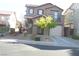 Two-story stucco home featuring a small front yard and an attached one car garage at 1158 Gecko Rd, Henderson, NV 89002