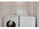 This dedicated laundry area features a side-by-side washer and dryer with overhead shelving for easy access at 1158 Gecko Rd, Henderson, NV 89002