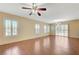Spacious living room with wood-look tile, plantation shutters, and a sliding glass door at 1158 Gecko Rd, Henderson, NV 89002