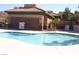 Community swimming pool surrounded by a black iron safety fence and lounge area at 1158 Gecko Rd, Henderson, NV 89002