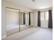 Bright bedroom with large mirrored closet and window with light-blocking curtains at 1201 Sulphur Springs Ln # 101, Las Vegas, NV 89128
