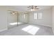 Bedroom with a large mirrored closet, ceiling fan, and natural light at 1201 Sulphur Springs Ln # 101, Las Vegas, NV 89128