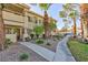 Apartment complex with well-maintained grounds, mature trees, and unit entrances at 1201 Sulphur Springs Ln # 101, Las Vegas, NV 89128