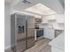 Modern kitchen with stainless steel appliances, white cabinets, and a skylight at 1201 Sulphur Springs Ln # 101, Las Vegas, NV 89128