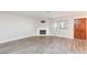 Bright living room features a painted brick fireplace, wood floors, and a sunny window at 1201 Sulphur Springs Ln # 101, Las Vegas, NV 89128