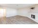 Open living room featuring a fireplace, mantle, and hardwood floors at 1201 Sulphur Springs Ln # 101, Las Vegas, NV 89128