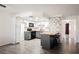Bright kitchen with wood floors, white cabinets, island with seating and accent tile at 1316 Driscoll Dr # 201, Las Vegas, NV 89128