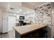 Kitchen with wood floors, white cabinets and accent tile at 1316 Driscoll Dr # 201, Las Vegas, NV 89128