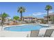 Community pool surrounded by lush landscaping and multi-story buildings at 1316 Driscoll Dr # 201, Las Vegas, NV 89128
