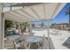 Community pool area with shade trellis, lounge chairs, and palm trees at 1316 Driscoll Dr # 201, Las Vegas, NV 89128