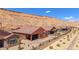 An overview of the backyard, highlighting the desert landscaping and mountain views at 1424 Pin Cushion Rdg, Mesquite, NV 89034