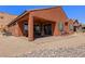 The backyard features a covered patio, desert landscaping, and views of the surrounding landscape at 1424 Pin Cushion Rdg, Mesquite, NV 89034