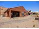 Backyard showcasing a covered patio, desert landscaping, and hillside views at 1424 Pin Cushion Rdg, Mesquite, NV 89034