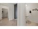 Hallway view featuring the pedestal sink bathroom on the right, and hallway leading to bedroom on the left at 1424 Pin Cushion Rdg, Mesquite, NV 89034