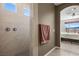 Tiled shower in bathroom with a view into the main bedroom overlooking mountain view at 1424 Pin Cushion Rdg, Mesquite, NV 89034