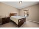 Comfortable bedroom with a wooden bed frame, bedside table, and neutral carpet at 1424 Pin Cushion Rdg, Mesquite, NV 89034