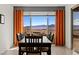 Mountain views through large windows enhance the dining area with stylish table and chairs at 1424 Pin Cushion Rdg, Mesquite, NV 89034