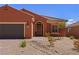 Charming single-story home with desert landscaping, brick-paved driveway, and a two-car garage at 1424 Pin Cushion Rdg, Mesquite, NV 89034
