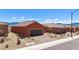 Street view of a single-story home with a brick driveway and low-maintenance desert landscaping at 1424 Pin Cushion Rdg, Mesquite, NV 89034