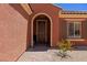 Inviting front entrance with arched doorway, a stone walkway, and colorful, drought-tolerant landscaping at 1424 Pin Cushion Rdg, Mesquite, NV 89034
