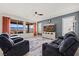 Inviting living room features large windows, ceiling fan, entertainment center and comfortable seating at 1424 Pin Cushion Rdg, Mesquite, NV 89034