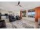 Bright living room with open floor plan, large windows showcasing beautiful views, and modern ceiling fan at 1424 Pin Cushion Rdg, Mesquite, NV 89034