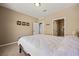 The bright main bedroom features neutral carpet, a queen bed, and ensuite bathroom access at 1424 Pin Cushion Rdg, Mesquite, NV 89034