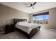 Relaxing main bedroom featuring a large bed, ceiling fan, and gorgeous mountain views at 1424 Pin Cushion Rdg, Mesquite, NV 89034