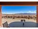 Mountain views from the outdoor seating area featuring an oval table at 1424 Pin Cushion Rdg, Mesquite, NV 89034
