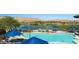 Resort-style pool with blue umbrellas, and golf course views at 1424 Pin Cushion Rdg, Mesquite, NV 89034