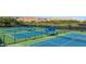 Outdoor tennis courts with nets and covered seating areas at 1424 Pin Cushion Rdg, Mesquite, NV 89034