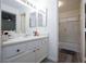 A well-lit bathroom features a tub-shower combo, single sink vanity, and neutral color palette at 1509 Linnbaker Ln # 203, Las Vegas, NV 89110