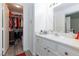 Bright bathroom featuring a closet, walk-in shower, single sink vanity, and neutral color palette at 1509 Linnbaker Ln # 203, Las Vegas, NV 89110