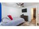 Bright bedroom featuring a ceiling fan, mounted TV, neutral walls, and colorful, patterned rug at 1509 Linnbaker Ln # 203, Las Vegas, NV 89110