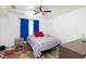 Bright bedroom featuring a ceiling fan, neutral walls, and colorful, patterned rug at 1509 Linnbaker Ln # 203, Las Vegas, NV 89110